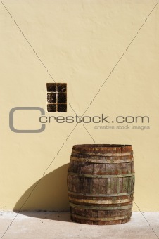 old barrel and yellow wall