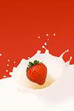 strawberry falling in milk