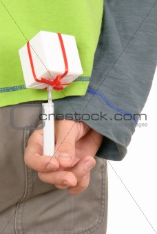 Syringe in gift behind back