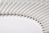Some white ballpount pens lie semicircle