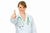 Smiling medical female doctor showing thumbs up gesture
