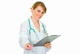 Smiling medical doctor woman holding clipboard and prescription drugs in hands
