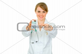 Smiling  medical doctor woman pointing finger on calculator
