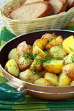 fresh potatoes fried in a pan with dill