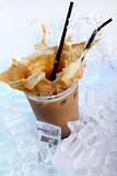 Cold coffee drink with ice and splashes