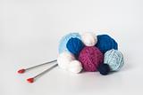 A lot of bright balls of yarn and knitting needle