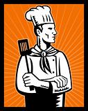 Retro chef cook holding spatula looking up