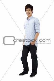 young man standing with hands in pockets
