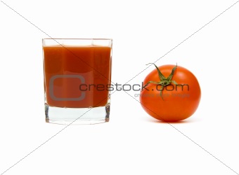 Ripe tomato and a glass of tomato juice.
