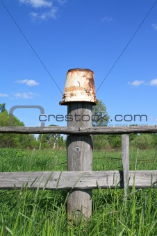 old pail on old fence