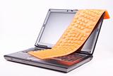 laptop and flexible orange keyboard isolated