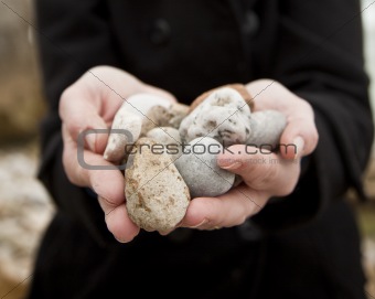 Woman holding pebbles