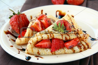 sweet thin french style crepes, served with strawberries,chocolate sauce