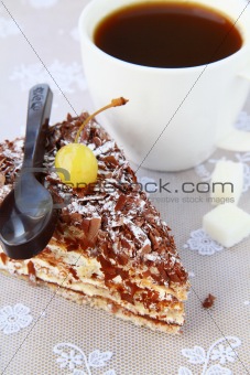 piece of chocolate cake decorated with chocolate spoon and cherry