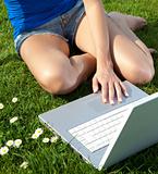Woman in park with laptop