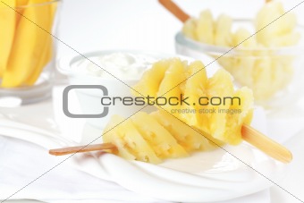 Pineapple skewer with curd cheese