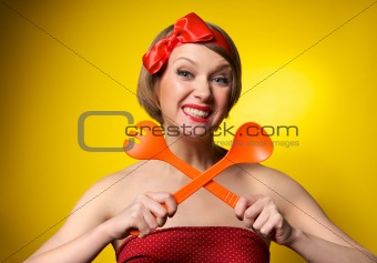 Pinup style housewife with kitchen utensils