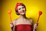 Pinup style housewife with kitchen utensils
