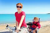daughter and mother on bicycle in beach sea