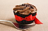 Cup cake with red bow and fork