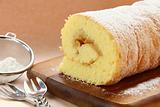 biscuit roulade with apple filling and powdered sugar