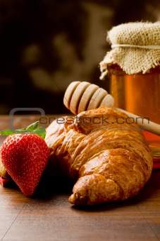 Croissants with honey and strawberries