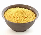 Brown bowl with couscous on white background