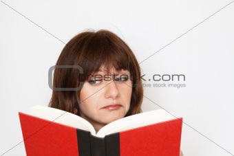 Young girl reading a book and wondering