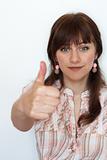 Handsome young woman with thumbs up on white background