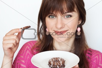 Young beautiful brunette eating delicious chocolate chip cookies