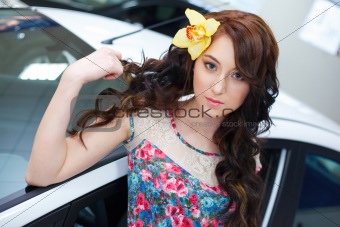 Young pretty woman with a New car
