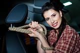 Young woman with rope inside New car with leather interior