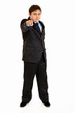 Full length portrait of smiling businessman pointing finger at you
