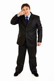 Full length portrait of smiling businessman showing contact me gesture

