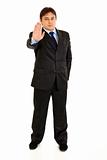 Full length portrait of confident modern businessman showing stop gesture
