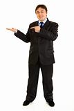 Full length portrait of smiling modern businessman pointing finger on empty hand
