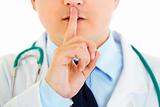 Medical doctor with finger at mouth. Shh gesture
