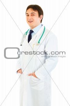 Smiling medical doctor with hands in pockets 
