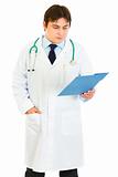 Concentrated medical doctor checking patients chart
