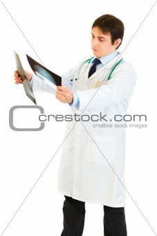 Concentrated doctor analyzing patients roentgen
