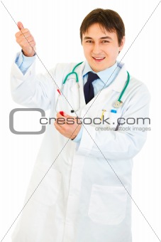 Smiling medical doctor  working with blood sample 
