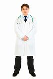 Full length portrait of confident medical doctor in uniform with stethoscope
