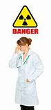  Concept-radiation hazard! Tired medical doctor woman holding hand near forehead
