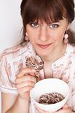 Young beautiful brunette eating delicious chocolate cookies