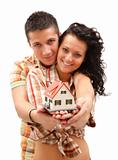 Happy couple with miniature house