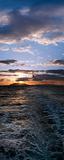 Panoramic sunset over boat motor ripples on the water