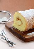 biscuit roulade with apple filling and powdered sugar