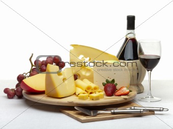 Cheese still life on a wooden round tray