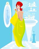Woman, girl in a bathroom dries hairs a towel before a mirror