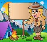 Scout girl holding board outdoor